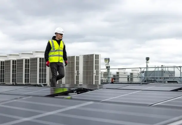 man walking along panels